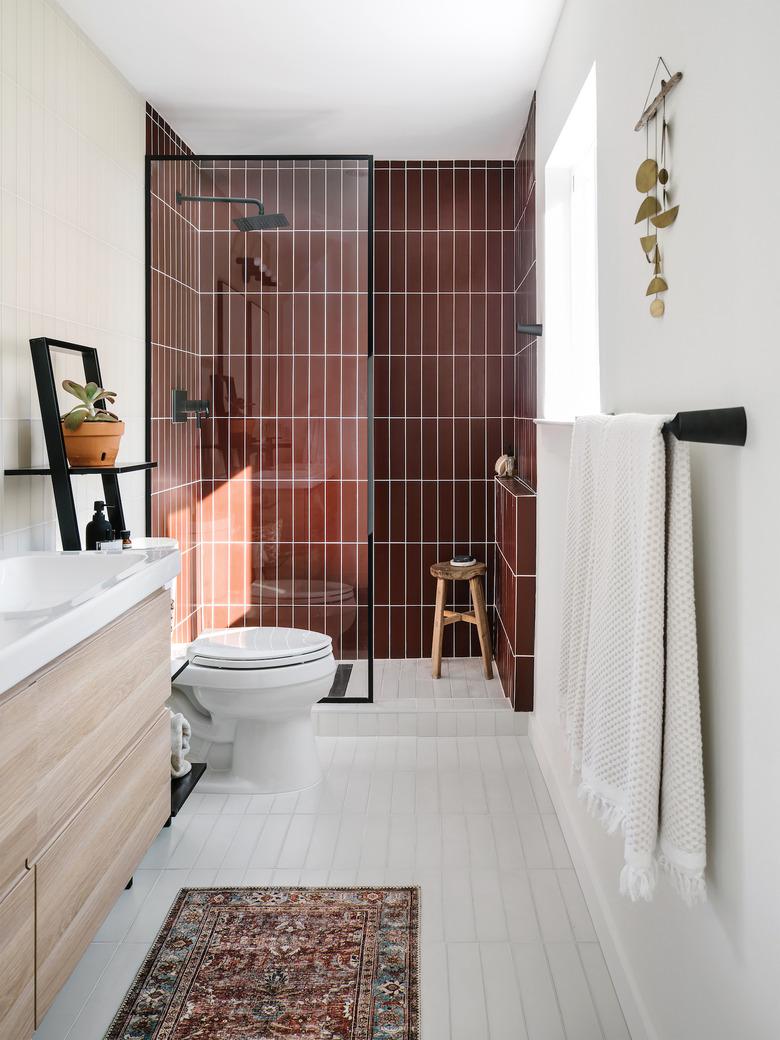 white bathroom with burgundy subway tile shower idea in the shower