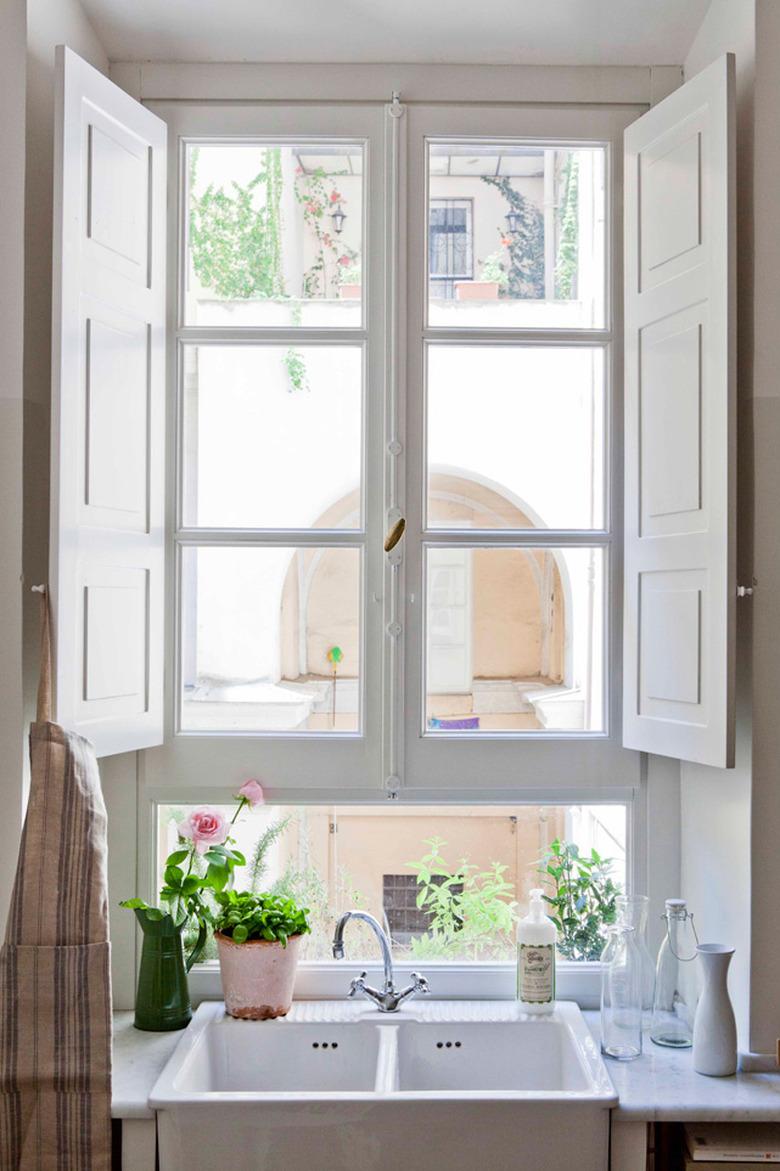 farmhouse kitchen with window shutters and double sink