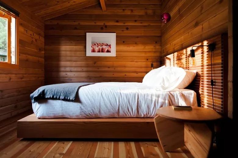 wooden paneled bedroom with a tech-free, simple design