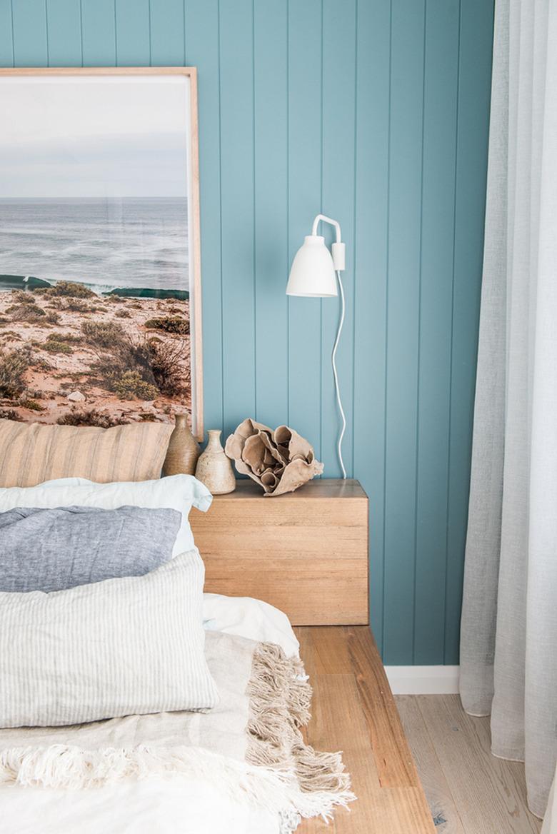 Coastal relaxing bedroom with blue wood panelled wall