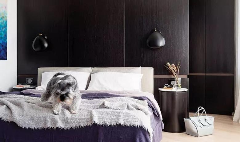 dark wood paneling on the wall of this cozy bedroom