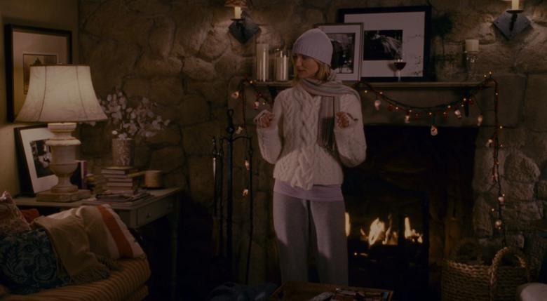 cameron diaz standing in front of a fireplace, still image from the holiday