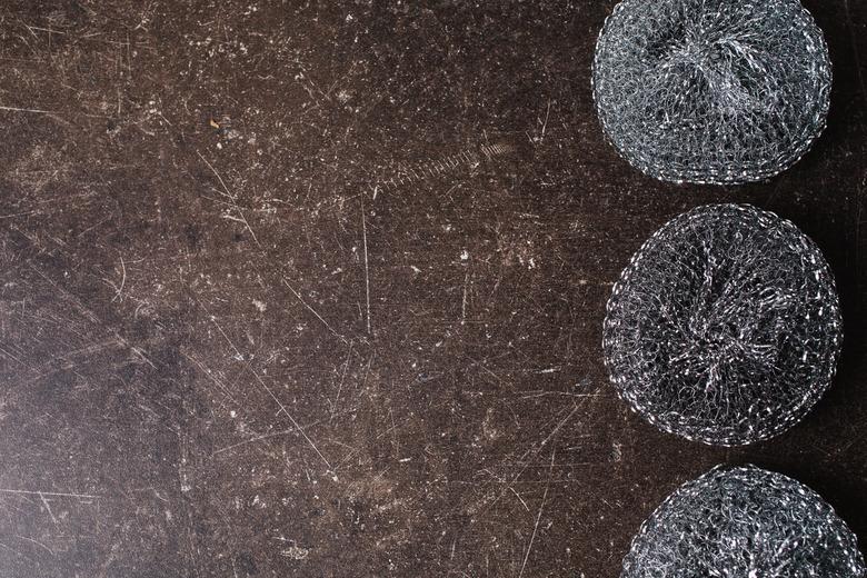 Metal sponges on a dark marble background. Items for hygiene and washing dishes