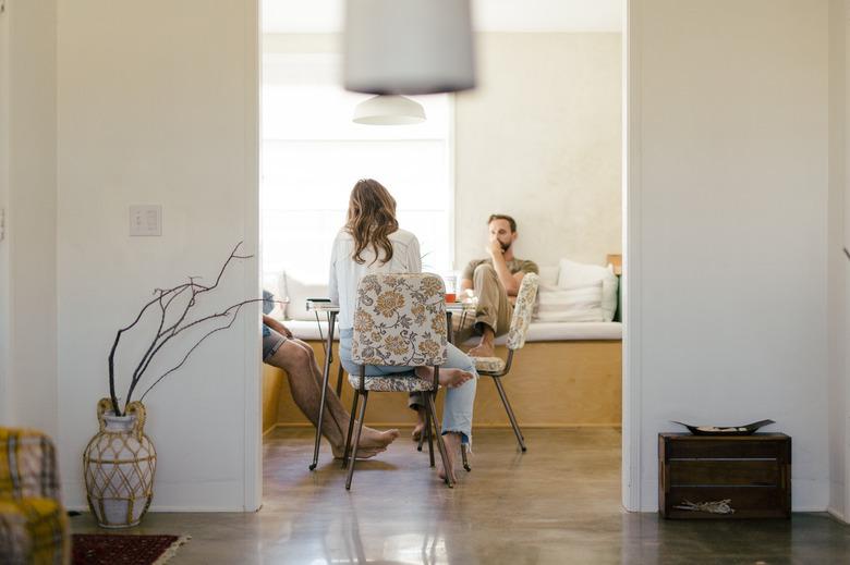 Three people sitting at the kitchen table