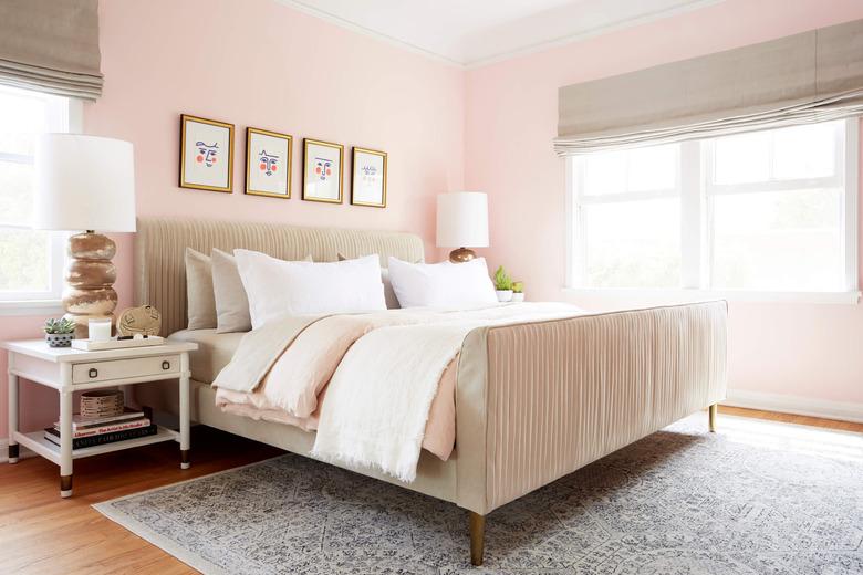 pink traditional bedroom color schemes with beige upholstered bed and roman shades