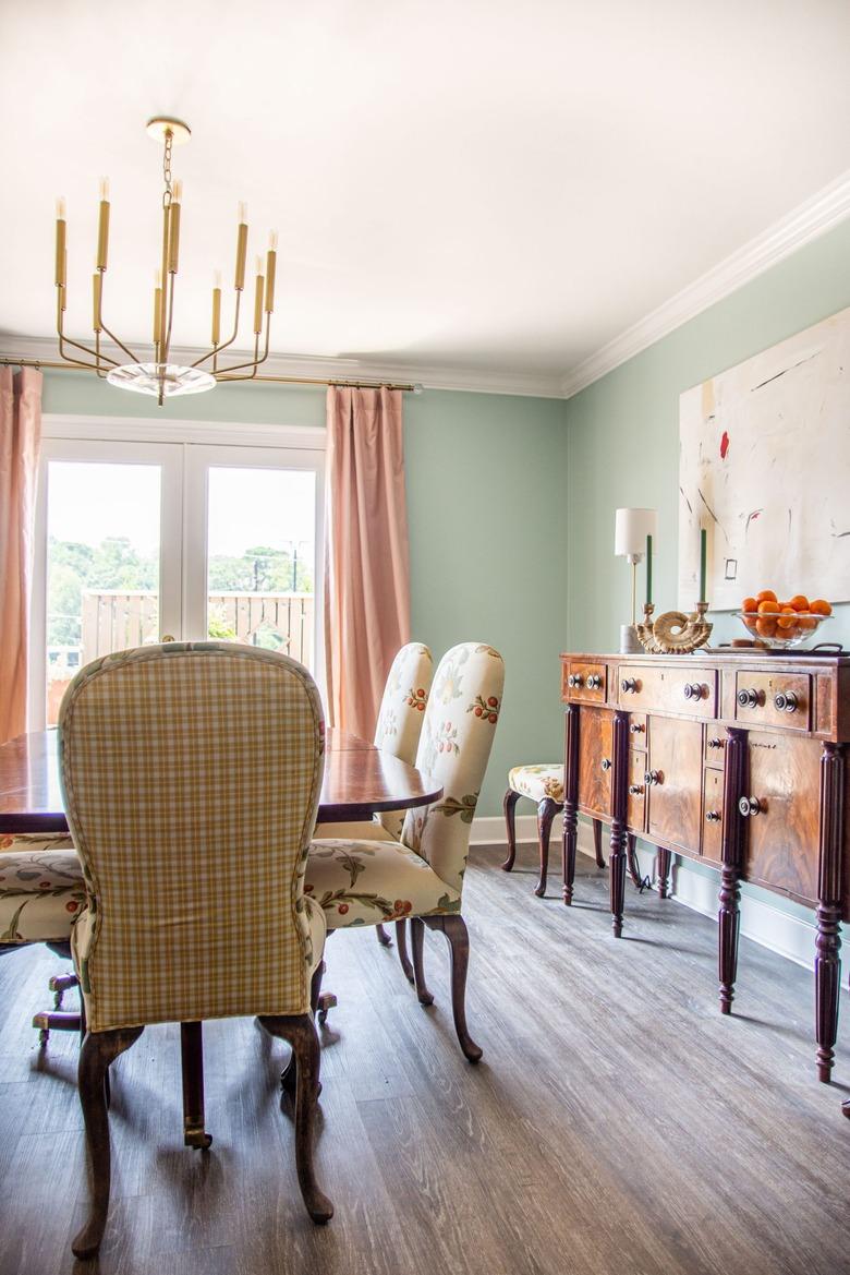 Green and pink vintage dining room with brass candelabra traditional dining room lighting