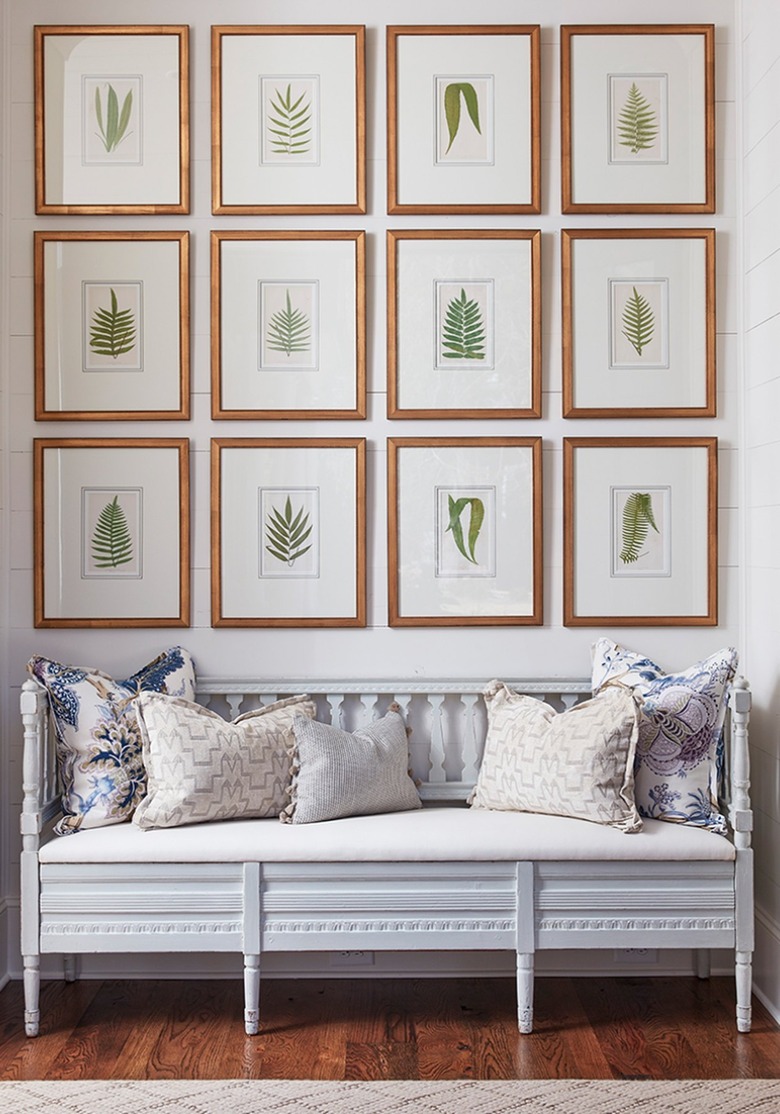 Hallway with gallery wall, bench, cushions.