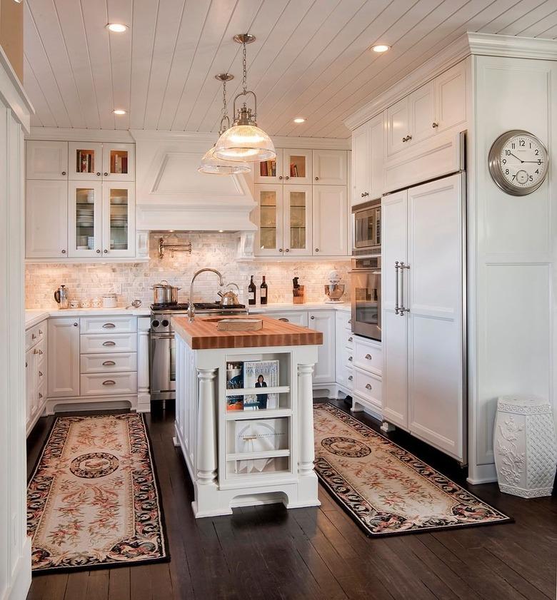 travertine backsplash in traditional white kitchen