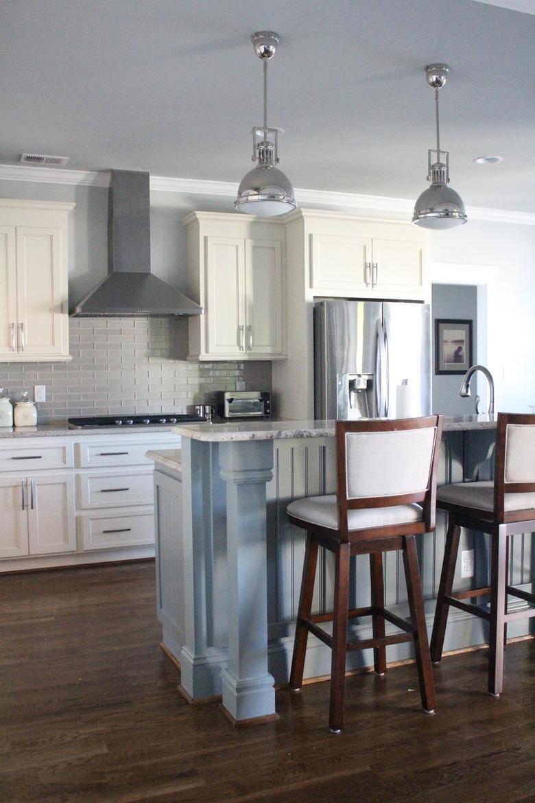 two-tier kitchen island with beadboard in white kitchen