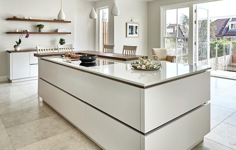 white two-tier kitchen island with small tier to use as table