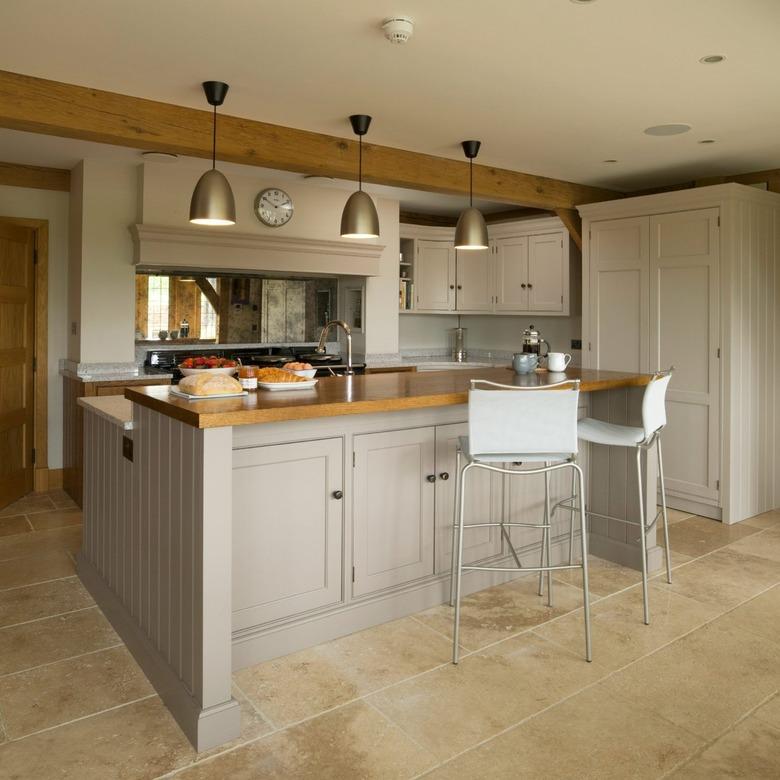 beige two-tier kitchen island with cabinets under bar