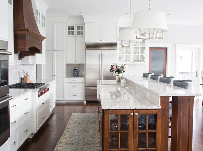 two tier kitchen island with white granite countertop and wood base