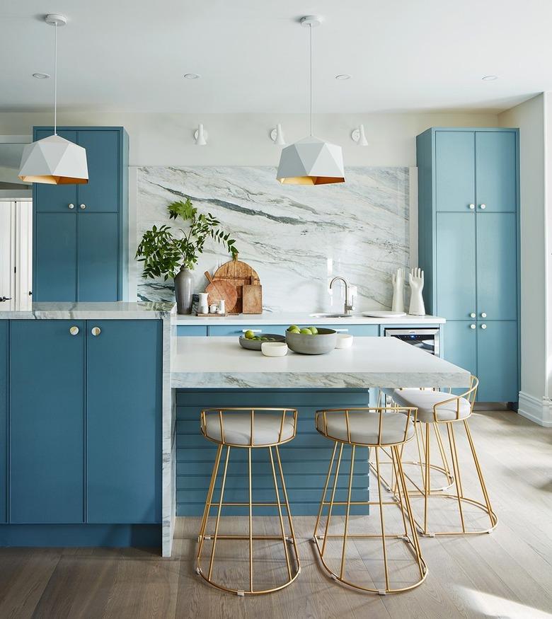 blue two-tier island with matching blue cabinetry