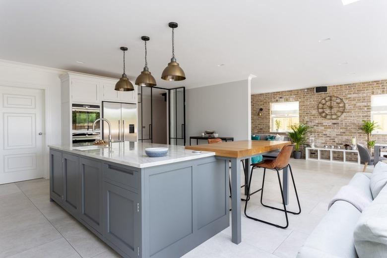 light blue two-tier kitchen island with small table attached