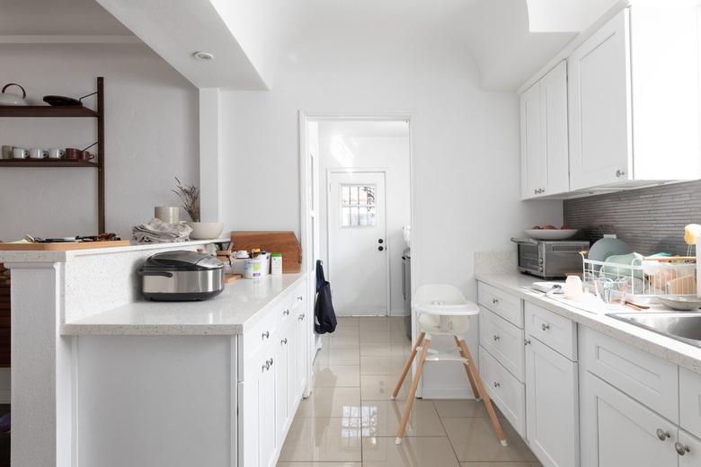 two-tier kitchen peninsula in white with white cabinets