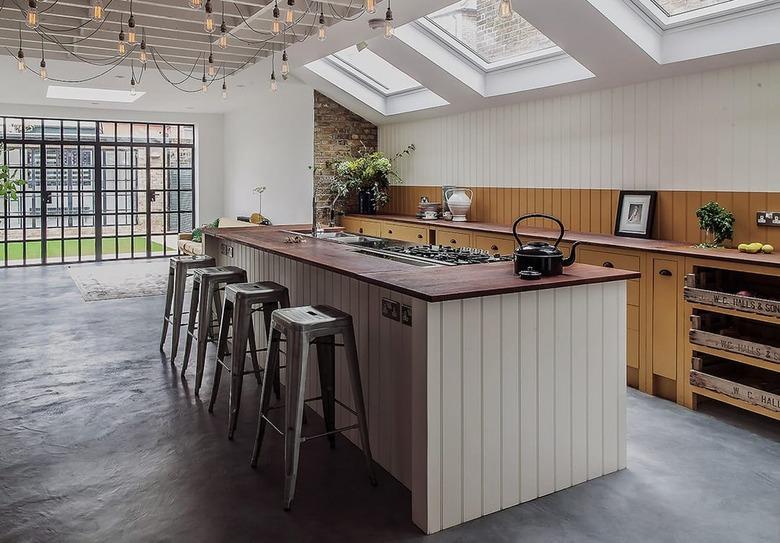 two-tone kitchen color idea with taupe and yellow kitchen cabinetry