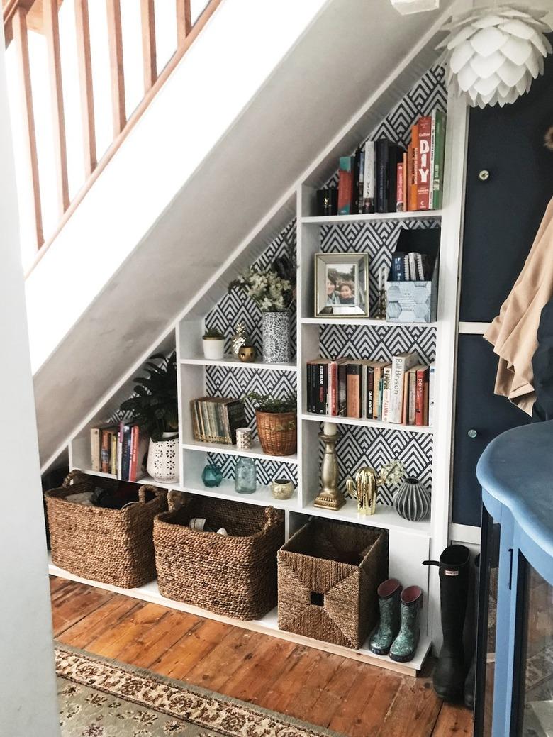 Under the stairs storage with white bookshelf and cubbies for decor and books