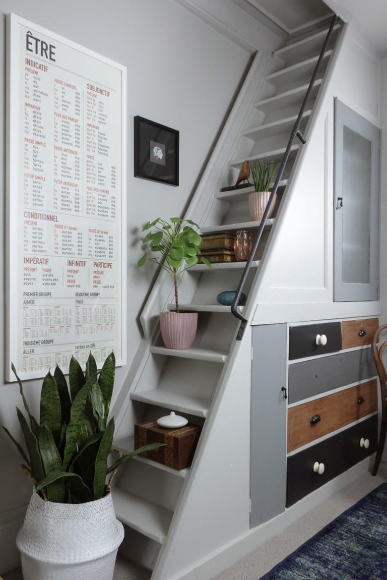 Under the stairs storage with mismatched vintage drawers and decor