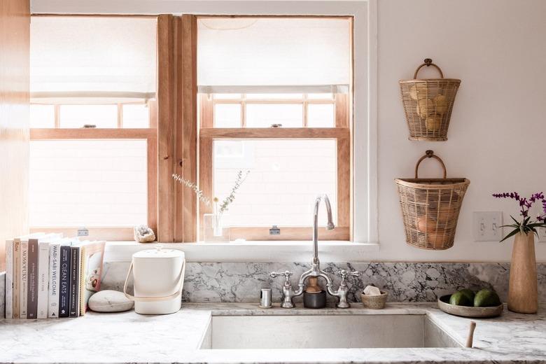 farmhouse sink and a gray countertop in a minimalist kitchen