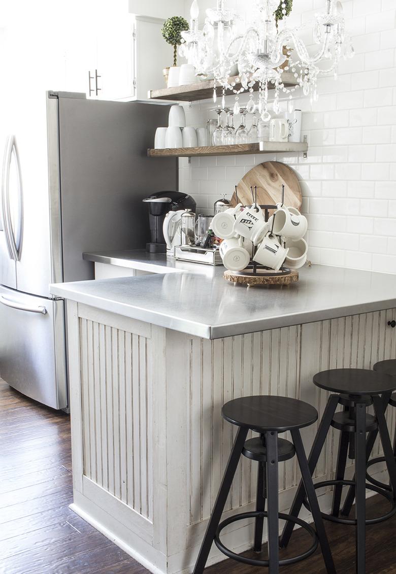 farmhouse kitchen with stainless steel countertops and white subway tile backsplash