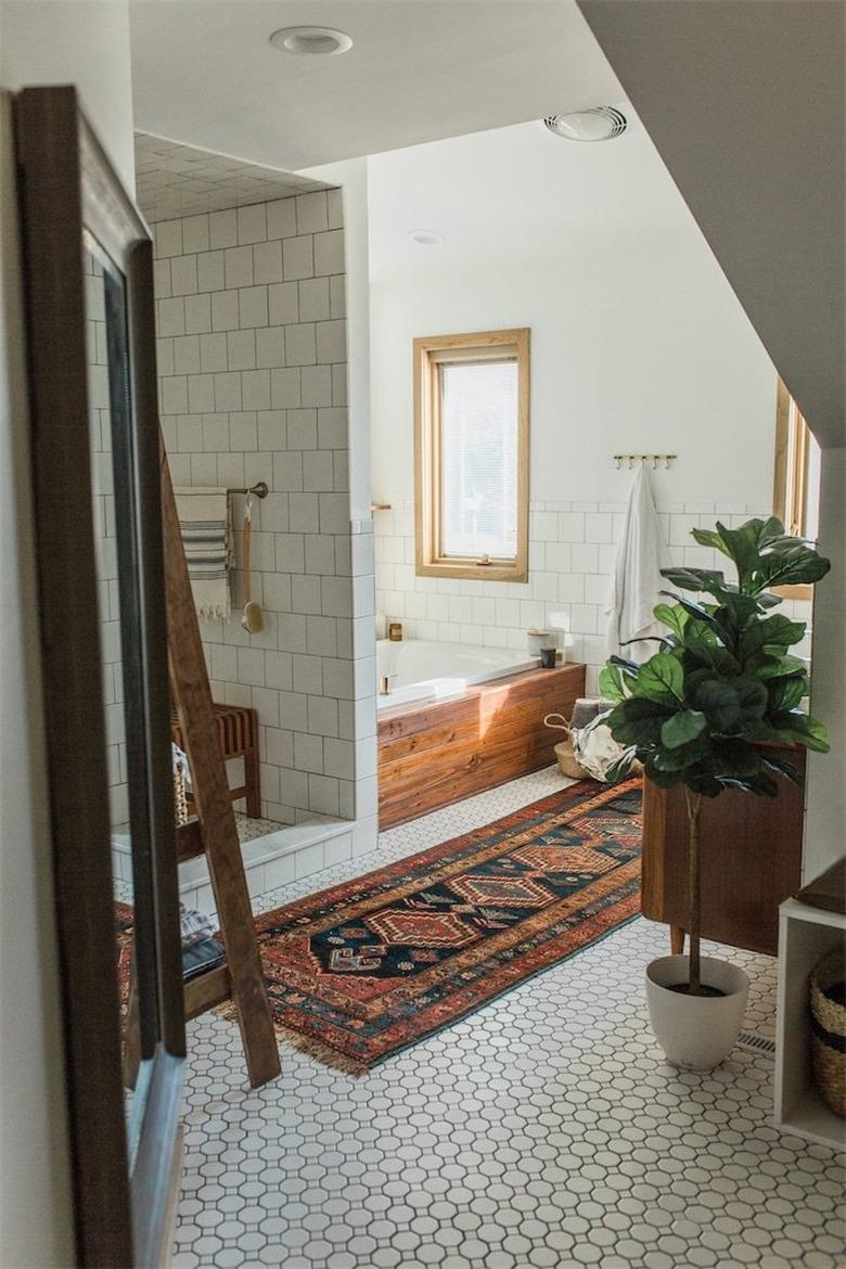 midcentury bathroom makeover with white mosaic floor tile and rug