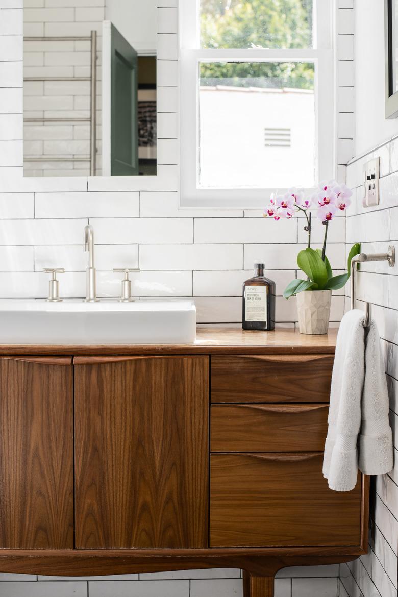 custom bathroom vanity with vessel sink and subway tile walls