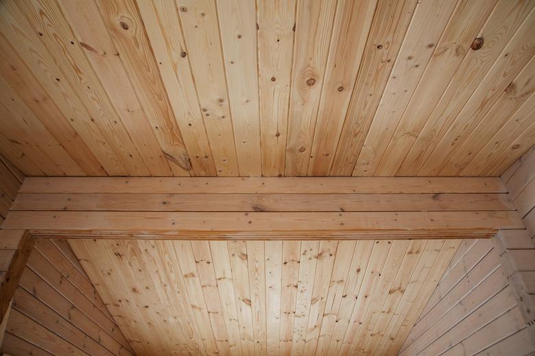 stages of construction of a house made of profiled wooden beams