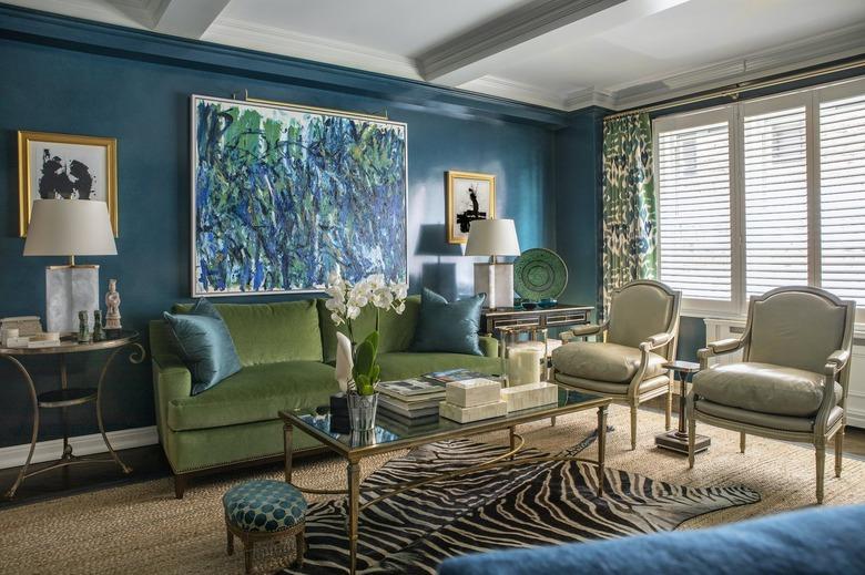 living room featuring an olive green couch and teal walls