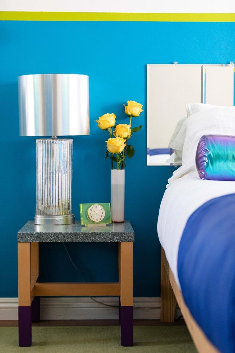 bedroom with blue walls and silver lamp