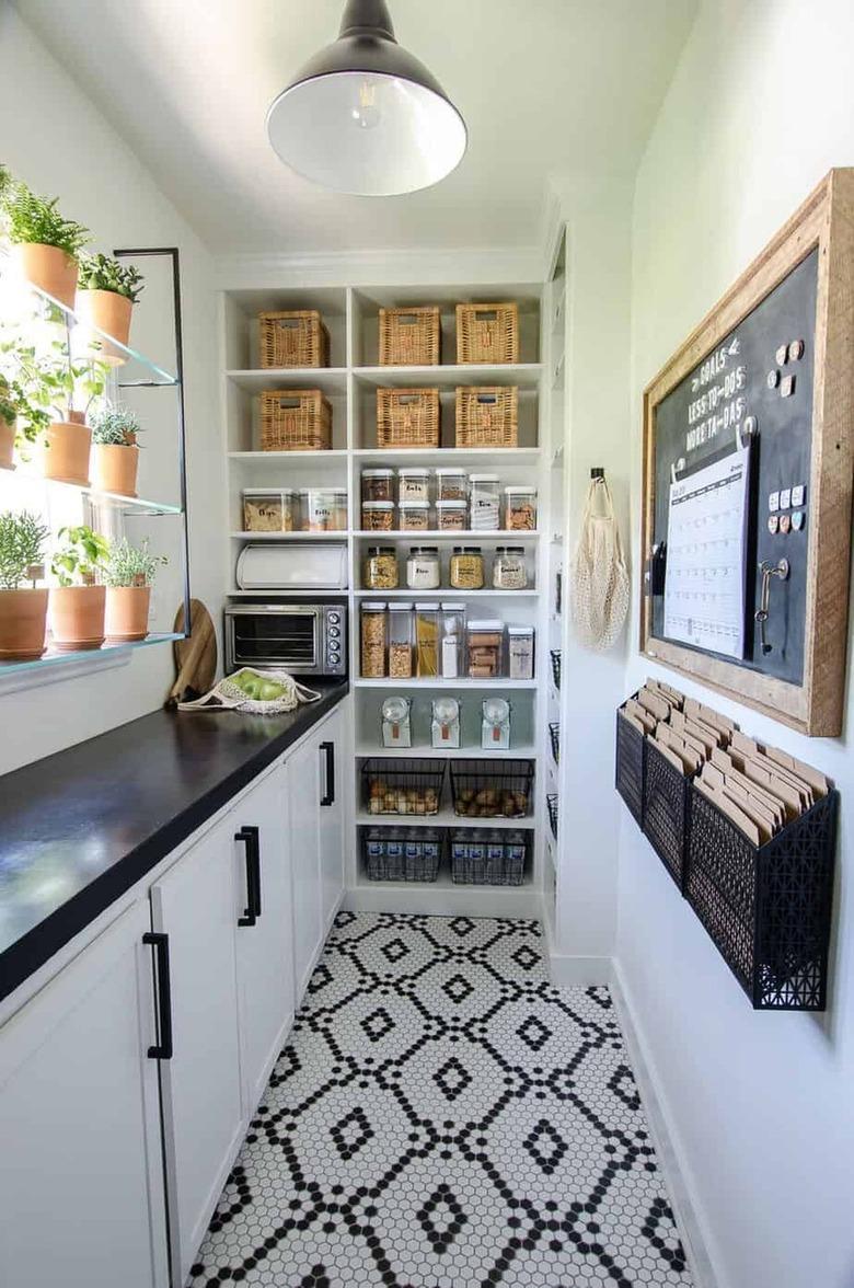 black and white butler's pantry with patterned tile floor and built-in shelving