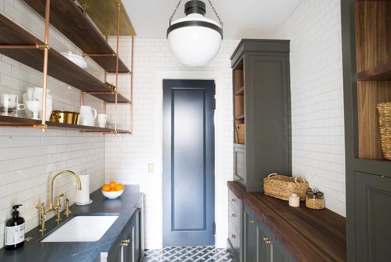 butler's pantry with subway tile walls and open shelving