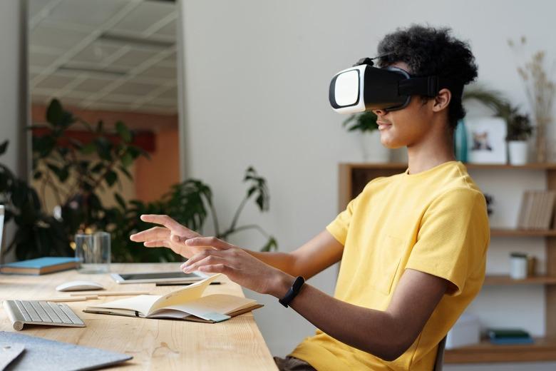 man wearing vr headset at desk