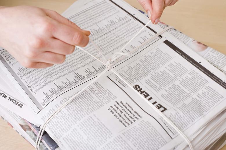 Tying a stack of newspapers.