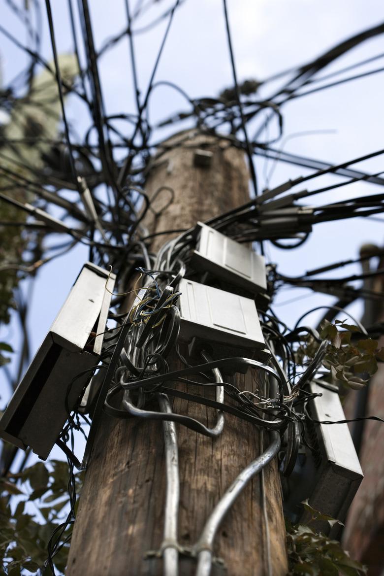 Utility pole with cables and boxes