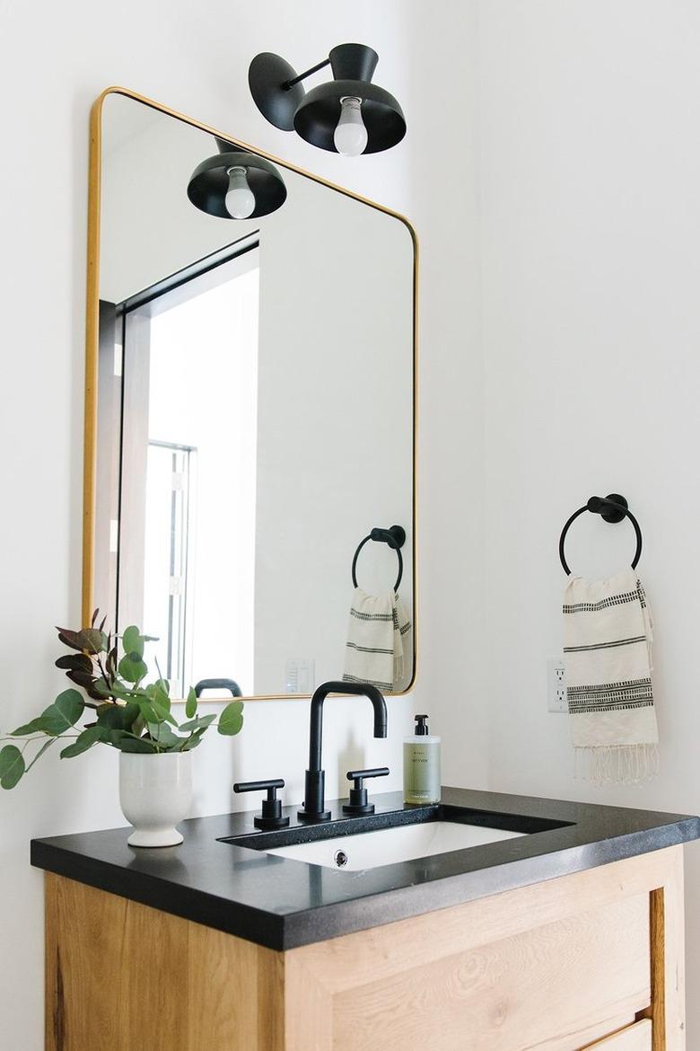 black quartz bathroom countertop with wood vanity cabinet