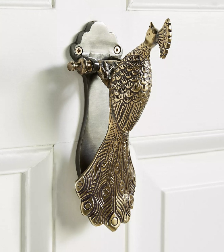 peacock door knocker on white door