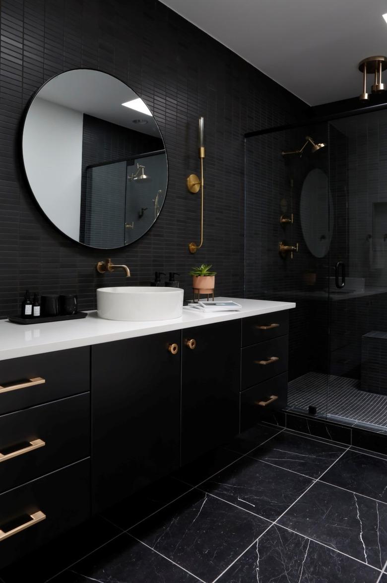 white bathroom countertop surrounded by black walls, flooring, and vanity cabinet