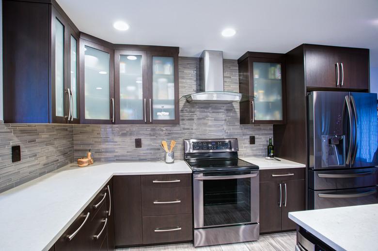 Updated contemporary kitchen room interior in white and dark tones.