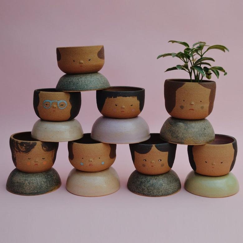 Wheel-thrown planters in the style of “niñas y chicos” (but with shoulders!) made from the 