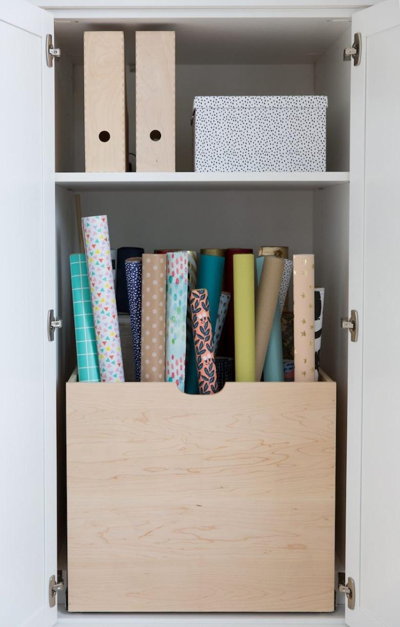 craft closet with wooden box for wrapping paper storage