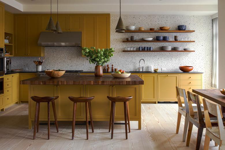 Warm yellow kitchen color idea with patterned tile backsplash.