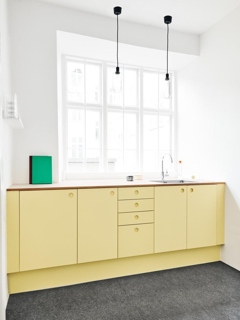 Soft yellow kitchen color idea with lower cabinets in yellow and bright white walls