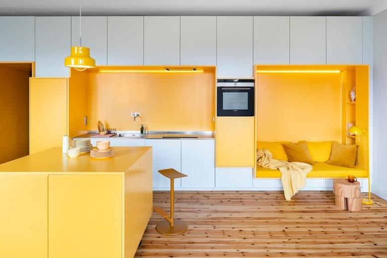 Contemporary yellow kitchen color idea with wood flooring