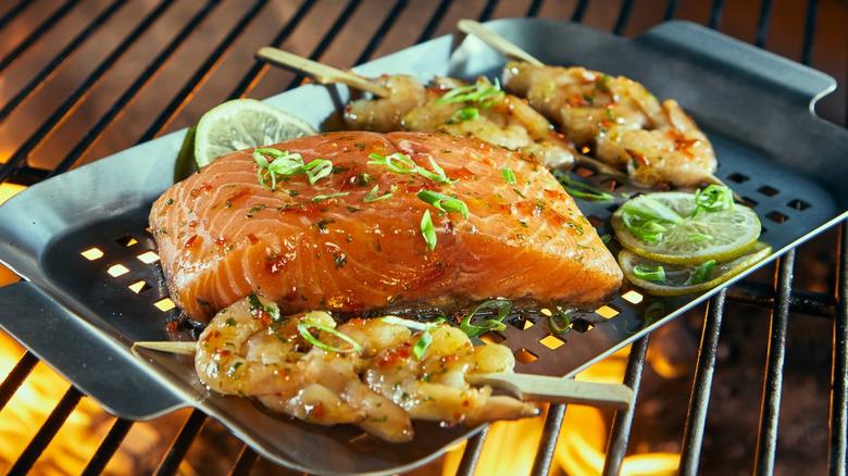 Grill tray on grill with salmon and shrimp