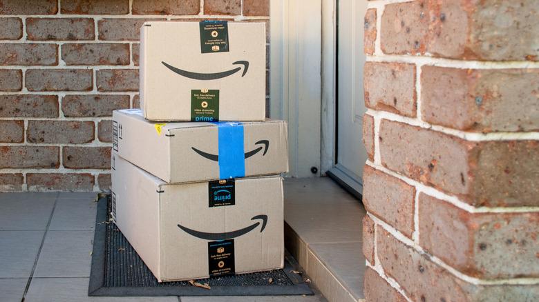 stack of Amazon prime deliveries stacked up in front of the entry door