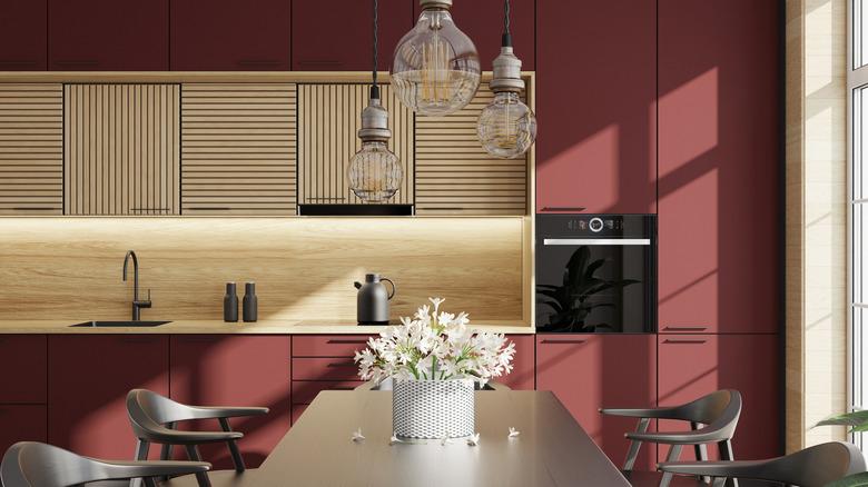 kitchen with burgundy cabinets, light wood countertop, light wood backsplash, light wood recessed upper cabinets, and a dining room table with four chairs