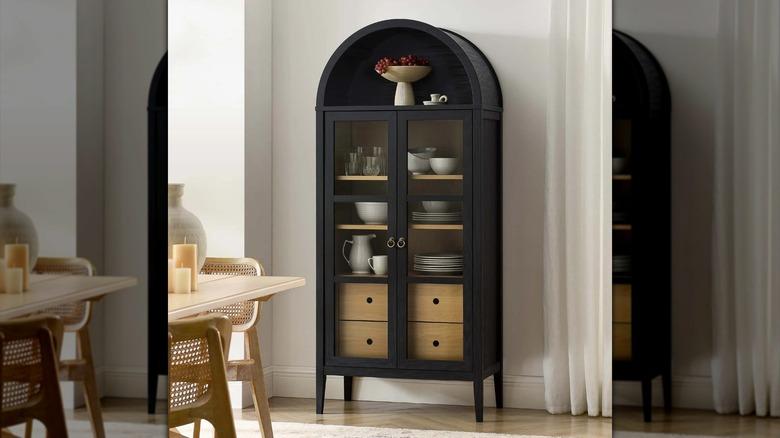 black arched cabinet with glass doors