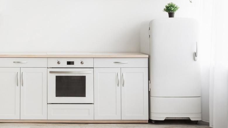 white kitchen cabinets, walls, and appliances