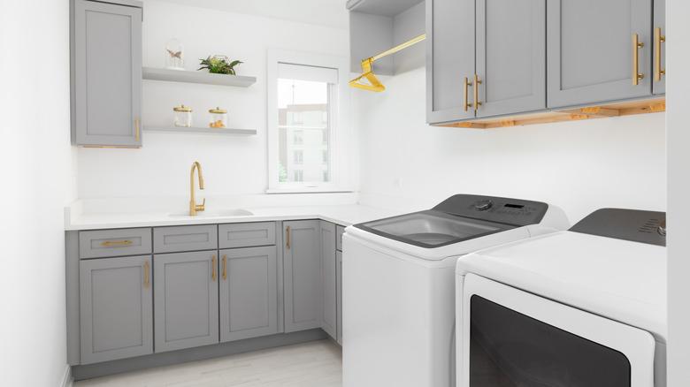 Laundry room with grey cabinets and a separate sink station