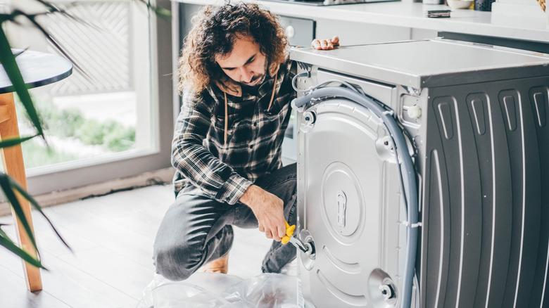 Man repairing a washing machine